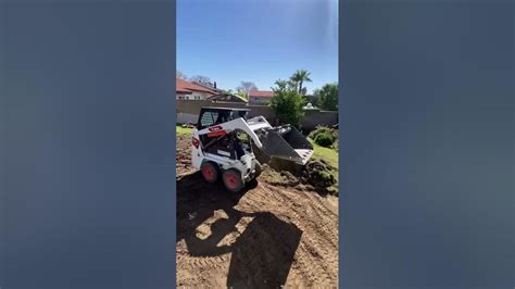 scraping a lawn with a skid steer|bobcat s70 sod removal instructions.